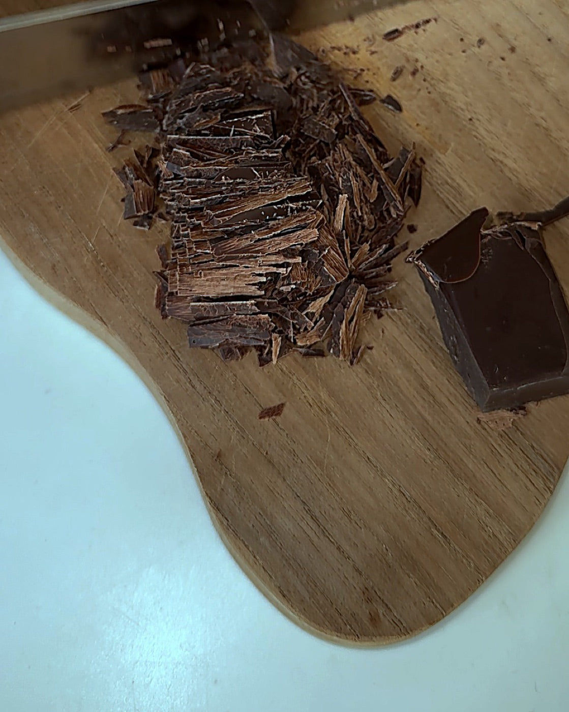 Shaving a piece of the NUDE 100% Cacao Bar before melting it into milk